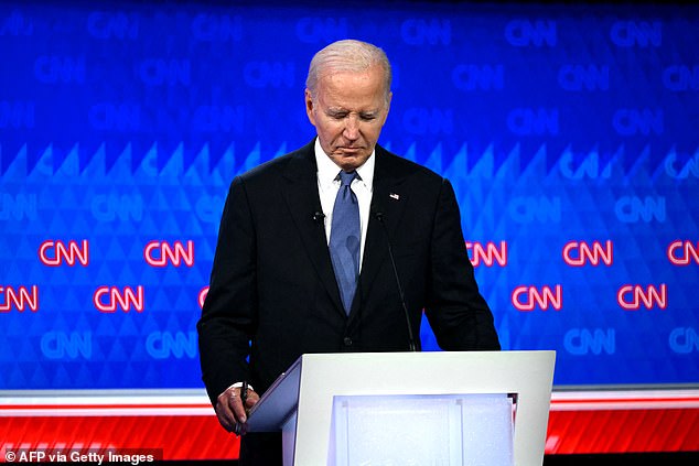 US President Joe Biden looks down as he participates in the first presidential debate of the 2024 election with former US President and Republican presidential candidate Donald Trump at CNN's studios in Atlanta, Georgia