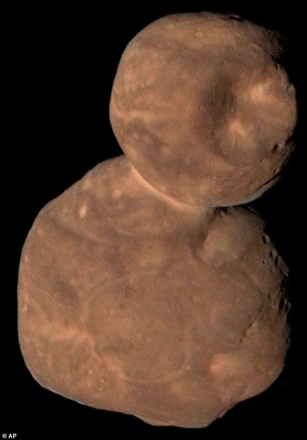 Arrokoth is a bizarre 'snowman-shaped' red rock in our solar system, about 4 billion miles from the sun.  Pictured is Arrokoth in a 2019 photo from NASA's New Horizons spacecraft