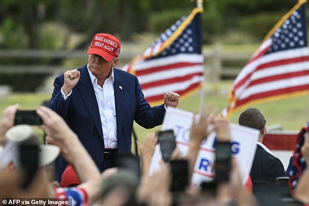 Former US president and Republican presidential candidate Donald Trump arrives on stage to speak at a campaign rally in Sunset Park