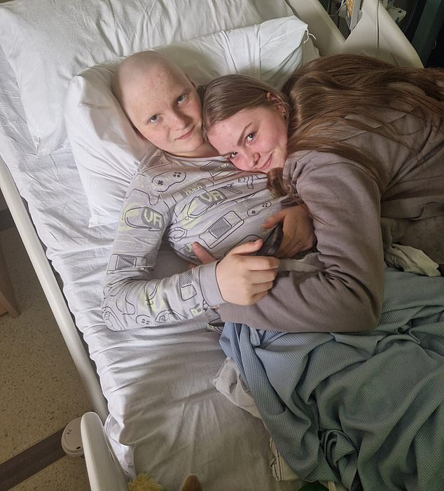 Jake Swinscoe, 13, with his big sister Ava in hospital.  Jake was diagnosed with stage three alveolar rhabdomyosarcoma, an extremely rare and aggressive soft tissue cancer that mainly affects teenagers and young adults