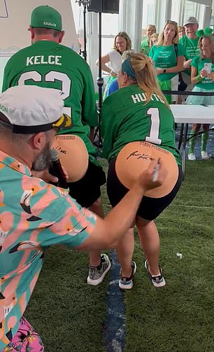 The 36-year-old Super Bowl champion signed the buttocks of two fans during his 'Beach Bash' in New Jersey