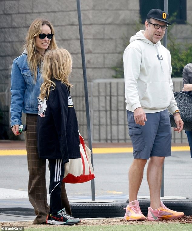 Jason Sudeikis (R) and his ex-fiancée Olivia Wilde (L) were amicably reunited in Los Angeles on Sunday for the sake of their children, including 10-year-old son Otis Alexander Sudeikis (M)