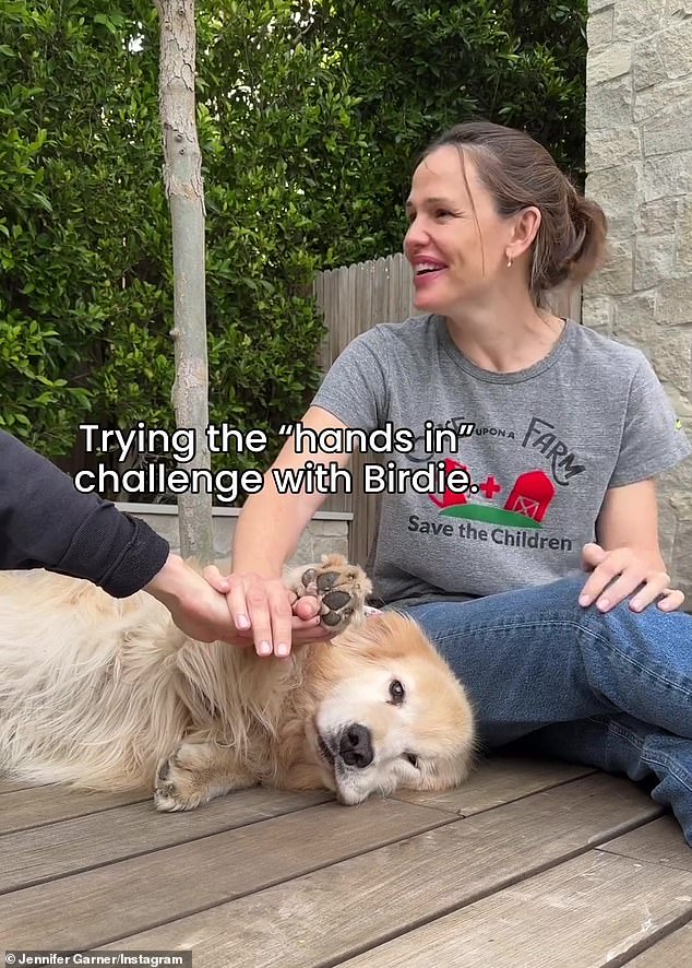 Her furry friend got it almost immediately and stuck his paw in on the 'first try', making Garner laugh