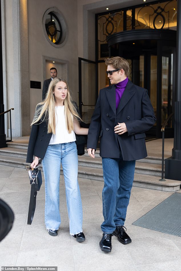 Joe Alwyn walked side by side with a female friend as he left his hotel in Milan, Italy, during the city's biennial fashion week on Sunday afternoon