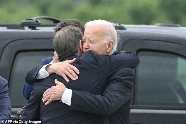 President Joe Biden hugs his son Hunter Biden on the tarmac at the Delaware Air National Guard as he rescheduled to fly to Wilmington after Hunter's guilty verdict