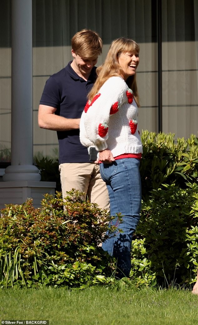 The mother of two had a casual look and wore a white cardigan decorated with strawberries, paired with jeans