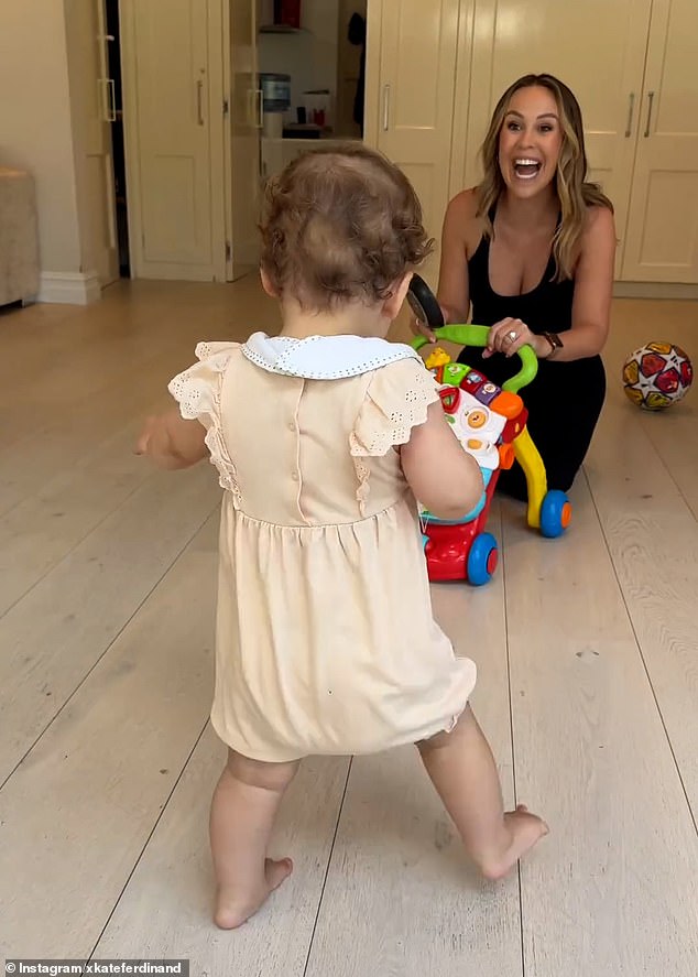 Kate Ferdinand beamed proudly over her daughter Shae, 11 months, as she taught the toddler to take her first steps in a heartwarming video shared to Instagram on Thursday