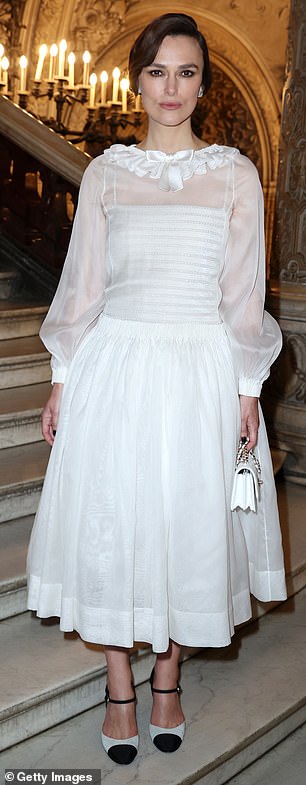 The Pride & Prejudice star, 39, opted for a white summer dress with sheer white sleeves as she beamed at the fashionable event