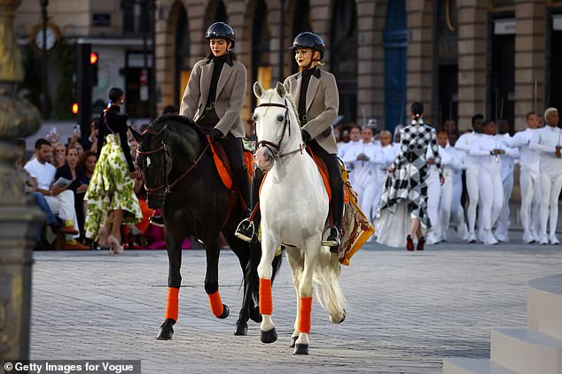 Kendall Jenner and Gigi Hadid rode the catwalk on horseback Sunday night as they led the star-studded Vogue World Paris show