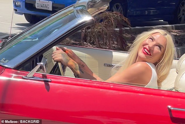 The Die Young artist beamed behind the wheel of a red convertible on a summer day in Southern California