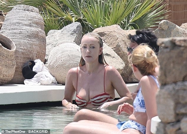 Jackie 'O' Henderson literally kicked up her heels as she went for a swim in her hotel pool in Mykonos, Greece on Wednesday