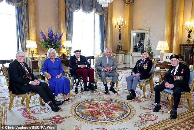 Charles and Queen Camilla pose for a photo alongside D-Day veterans Arthur Oborne, Jim Miller, Bernard Morgan and John Dennett