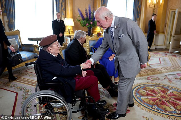 King Charles shook hands with D-Day veteran Jim Miller at Buckingham Palace yesterday