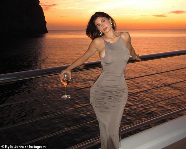 Kylie Jenner, 26, wowed her fans on Sunday when she posted some sultry photos with the Spanish sunset in the background.  The reality star was holidaying on a yacht off the coast of Mallorca with her mother Kris, 68, and sister Kendall, 28