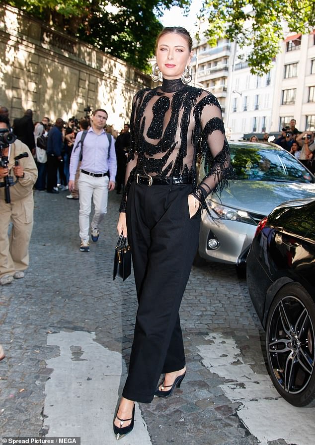Maria Sharapova turned heads in a daring sheer top as she arrived at the Schiaparelli Haute Couture show during Paris Fashion Week on Monday morning