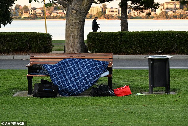 The agent then asked the tenants to 'pay with me by donating your discount' (stock photo of a homeless person on a park bench)