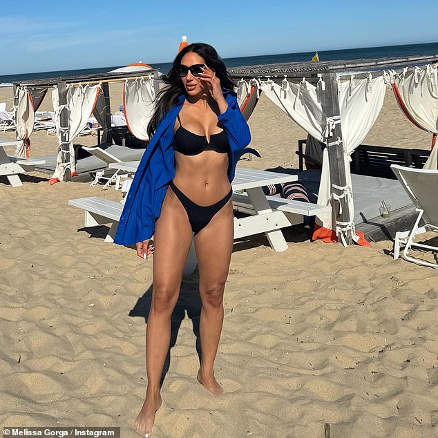 Melissa Gorga posed in the Hamptons this weekend in a tiny black bikini from Envy by MG