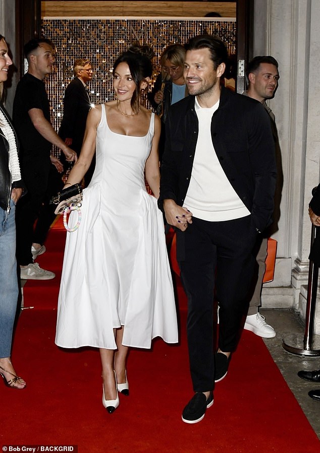 Michelle Keegan and Mark Wright put on a loving display as they left the M&S Ambassador Launch in London on Thursday