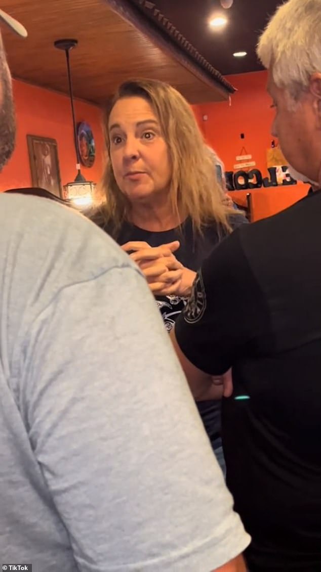 A group of customers lined up behind Madi, placed themselves between the young mother and the out-of-control woman and told the smoking woman to calm down.  The woman then erupts and violently yells at the surrounding customers, 