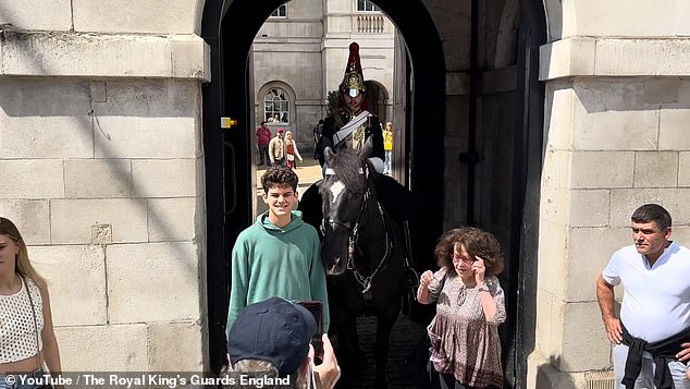 A woman stood next to the black horse to pose for a photo and was apparently unaware of the King's Guard advice to tourists stating that horses are allowed to kick or bite