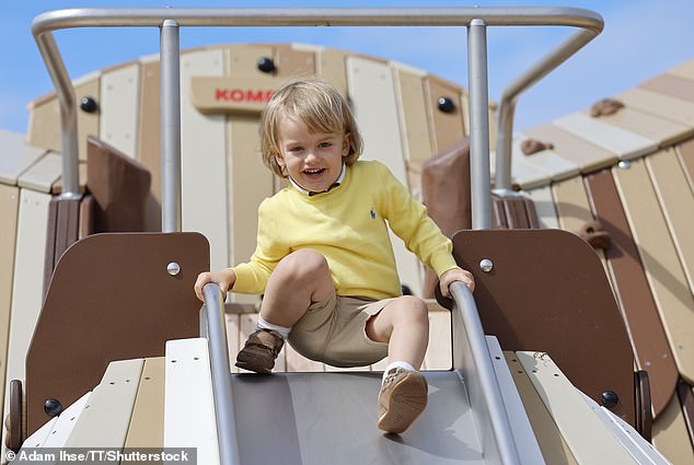 Prince Julian, wearing a yellow Ralph Lauren sweater and beige shorts, went down the slide and clearly had fun doing it