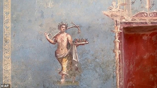 The walls of the room were a beautiful bright blue with frescoes of female figures representing the four seasons