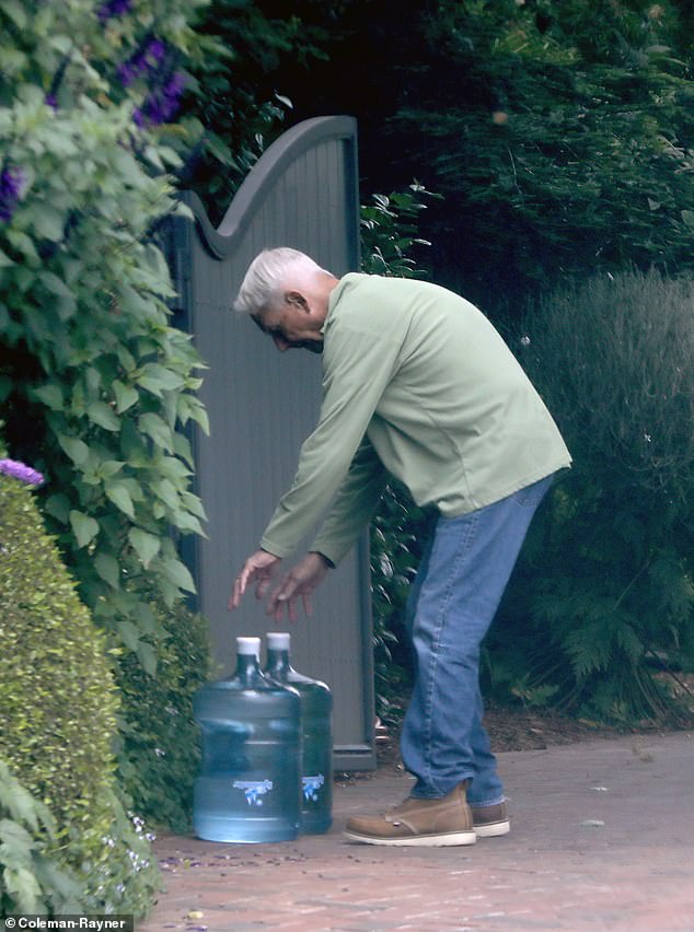 He effortlessly lifted not one, but two hefty water jugs – each weighing at least 42 pounds – as he walked back to his residence in Pacific Palisades.