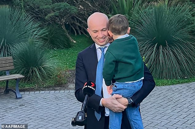 Matt Kean hugs his son Tom after his shock resignation from politics