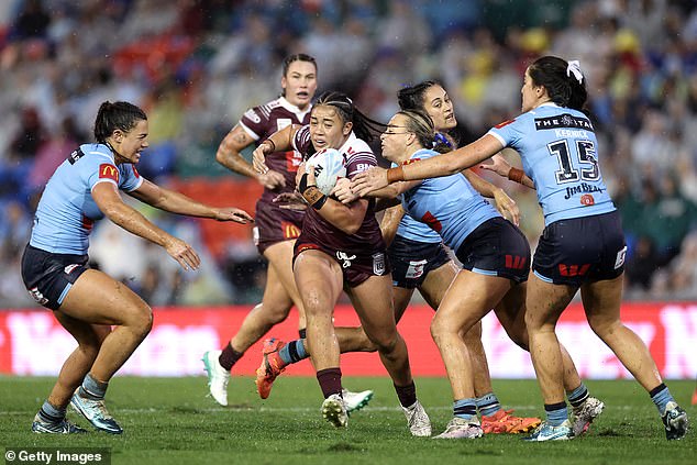 Sienna Lofipo of the Maroons is tackled during the match in front of a record crowd