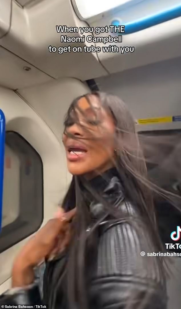 Naomi blew her hair in the wind while wearing a cropped leather biker jacket, baggy jeans and Nike sneakers