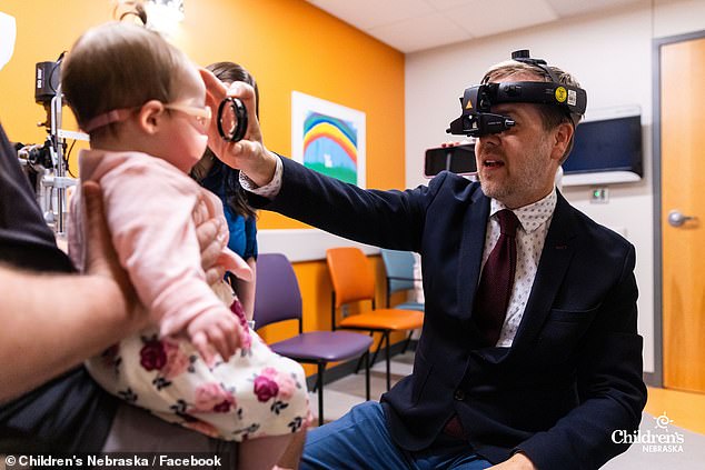 The Artales took their daughter to Dr.  Rychwalski (pictured) who performed three surgeries in Madison over nine months, including two when she was a newborn, which saved her sight.