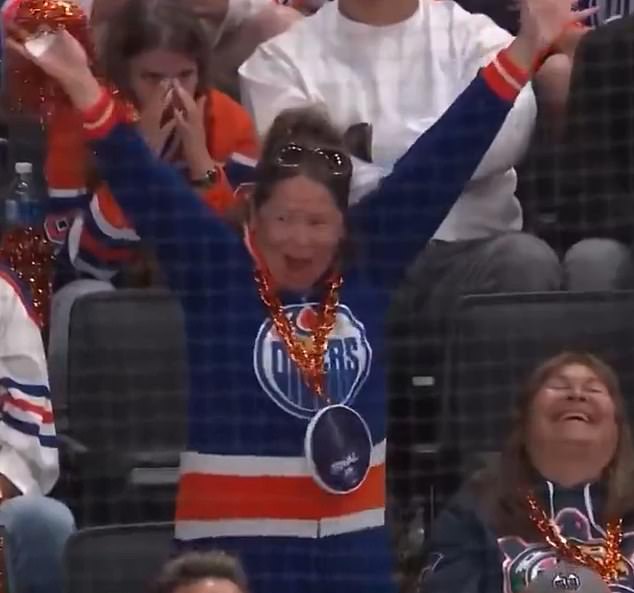 An unknown Oilers fan was seen weirdly celebrating her team scoring a goal
