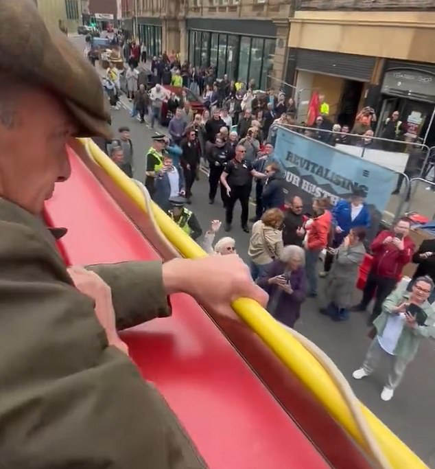 Nigel Farage was today targeted by an attacker, who is not pictured, as he threw objects during an open-top bus tour in Barnsley