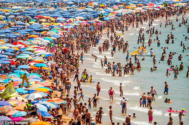 A busy beach in Benidorm, part of the Costa Blance in Spain