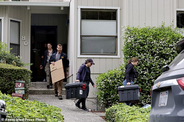 FBI agents carry boxes from a home linked to Oakland Mayor Sheng Thao during a raid in Oakland, California, Thursday