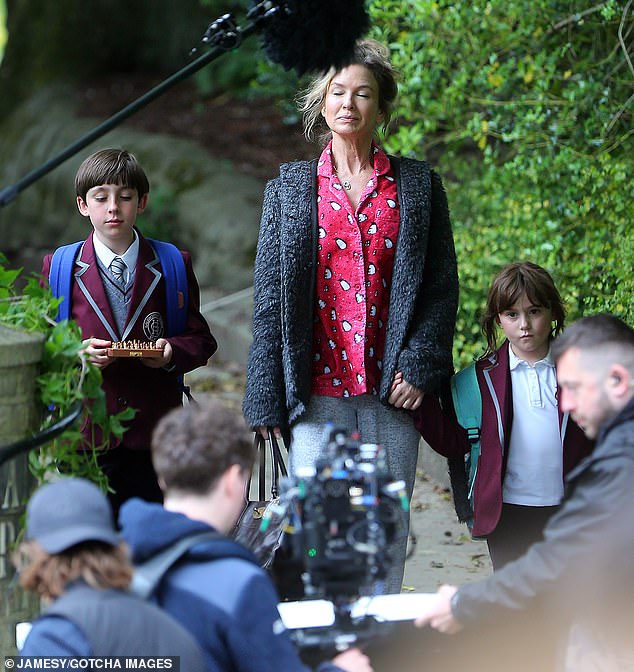 Renee Zellweger looks disheveled while filming the school scene for Bridget Jones 4 in penguin pajamas and a necklace with 'late' husband Mark Darcy's initials