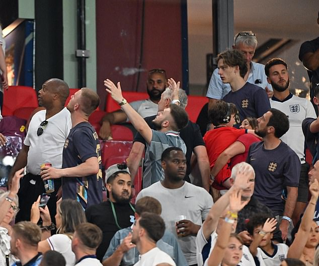 Relatives of England players were drenched in beer after fans threw cups following their draw against Slovenia