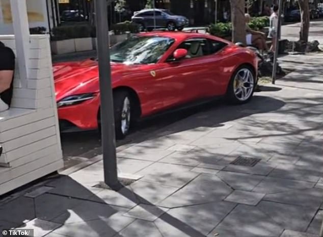 A red Ferrari Roma V8 coupe (pictured) was spotted in Double Bay, in Sydney's eastern suburbs, with the left rear parked on the curb