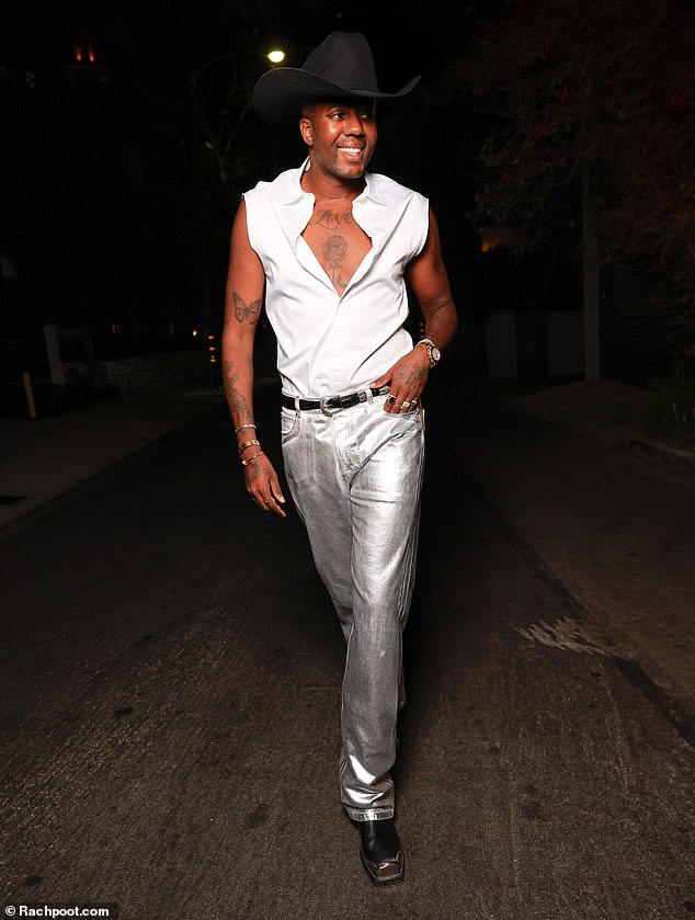 Vas, 35, bared his inked chest in an unbuttoned white shirt, paired with trendy silver metallic jeans