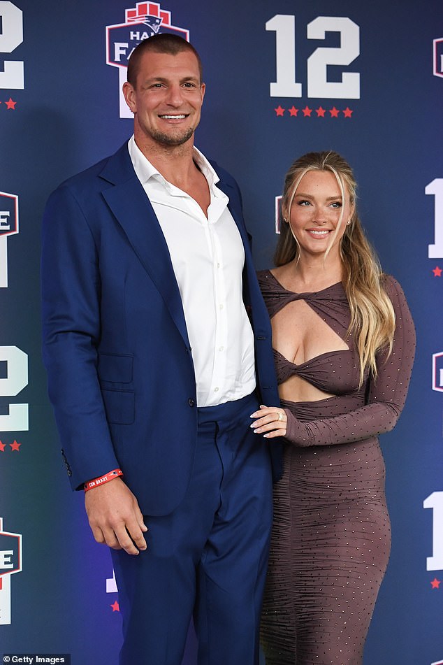 Camille Kostek poses for a photo with boyfriend Rob Gronkowski during Tom Brady's New England Patriots Hall of Fame induction ceremony in Foxborough, Massachusetts