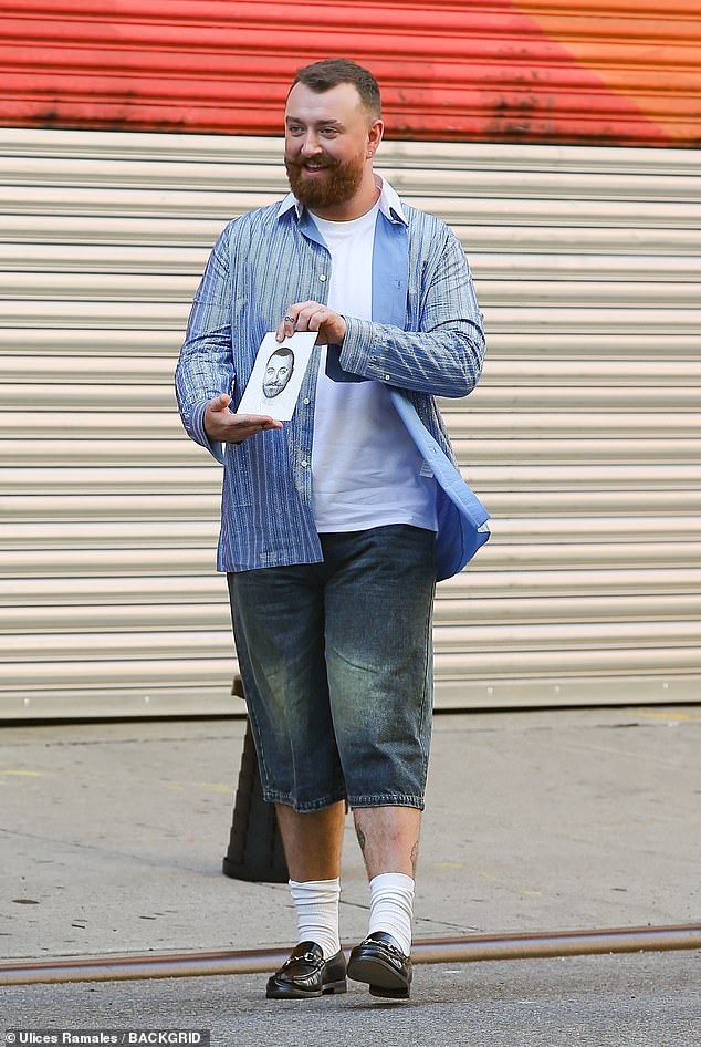 Sam Smith, 31, looked happy after getting their portrait drawn while in New York City on Thursday