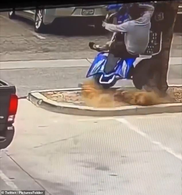 The footage shows the man driving out of a parking lot in the blue ATV, but shortly afterwards crashing head-on into a tree at full speed.