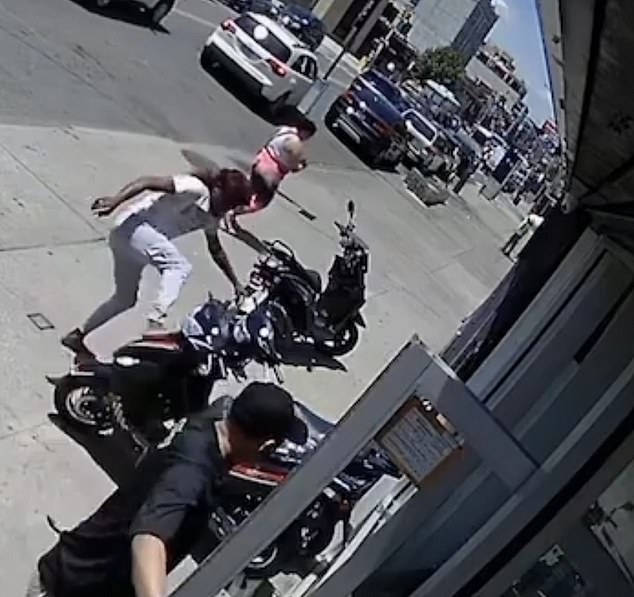 In a final burst, the suspect then kicked a parked scooter onto the sidewalk