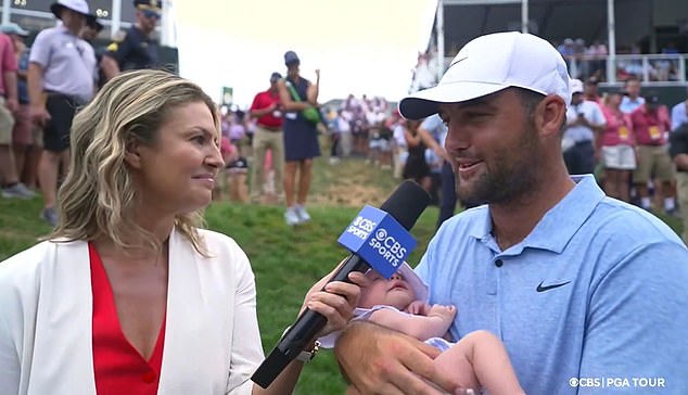 Scottie Scheffler fought back tears as he held his newborn baby in an emotional interview with Amanda Balionis