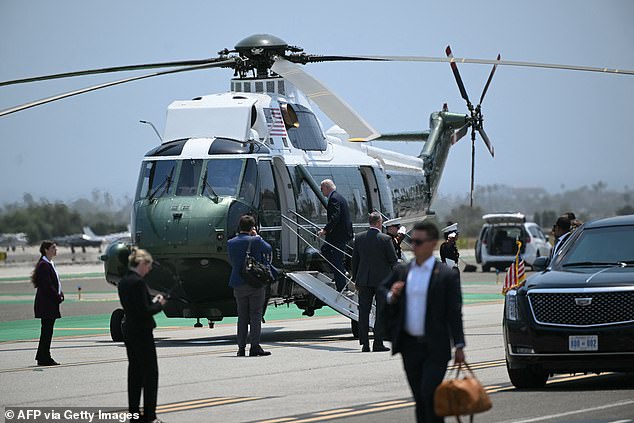 Secret Service agents and other auxiliaries are seen around Marine One in Los Angeles on Sunday.  A Secret Service employee's bag was stolen during an armed robbery in Orange County, California, on Saturday evening, the night of Biden's expensive fundraiser
