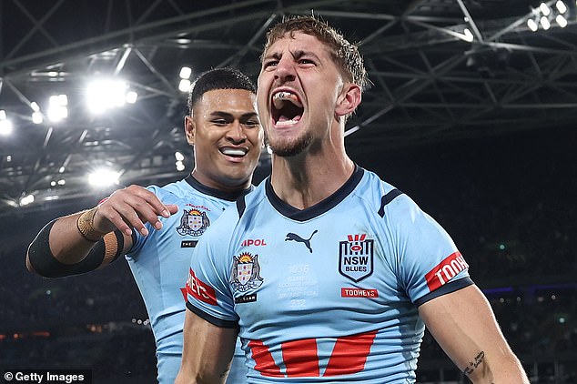 A popular campaign group has called for State of Origin to be banned after higher levels of domestic violence were linked to the interstate matches (pictured as the NSW Blues celebrate a try on Wednesday night)