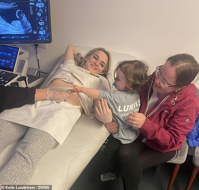 The 20-year-old mum, pictured with a scan alongside the support of her mum Katie (right) and her one-year-old son Liam (held by Katie)