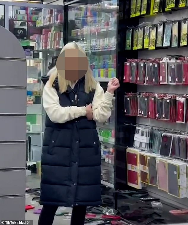 This is the shocking moment a customer vandalizes a west London phone shop and racially abuses an employee for 'refusing' to give her money back