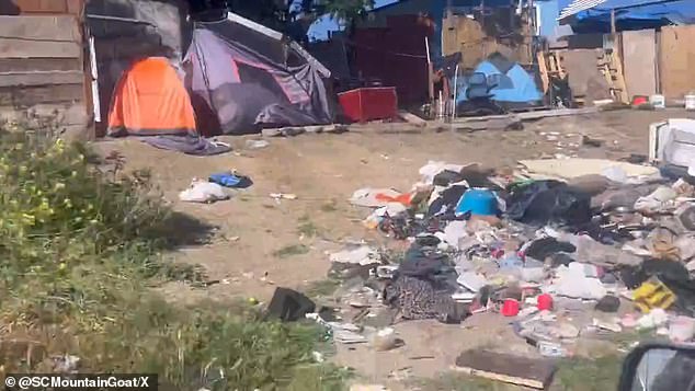 The footage showed trash built from wood, tarpaulin and other discarded materials being collected around homes