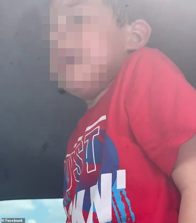 On Friday around 2pm, a one-month-old baby, a two-year-old child and a four-year-old child were rescued from a stationary car after a passerby found them trapped inside. (pictured: a crying boy in the car)